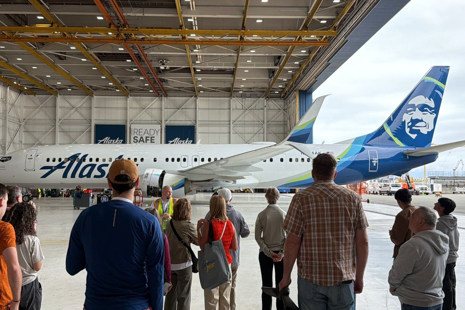 Aviation Expo attendees touring an Alaska Airlines Boeing 737 hangar